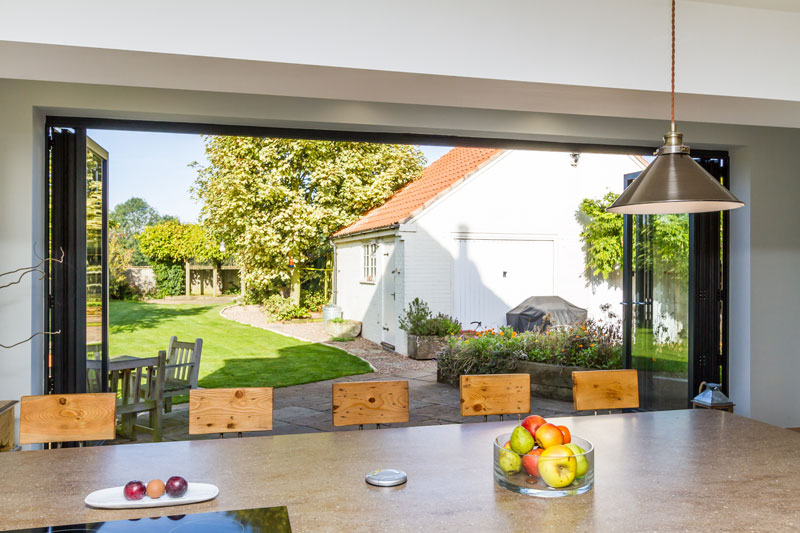 home backyard view with bi-fold doors