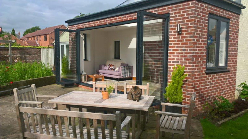 home backyard view with bi-fold doors