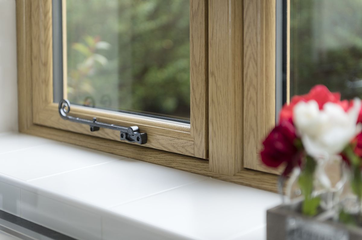 Cottage window shown from the inside, with a window stay. Modern PVCu window, recreating a timber cottage look.
