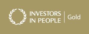 Investors in People Gold Logo, white text on a gold background